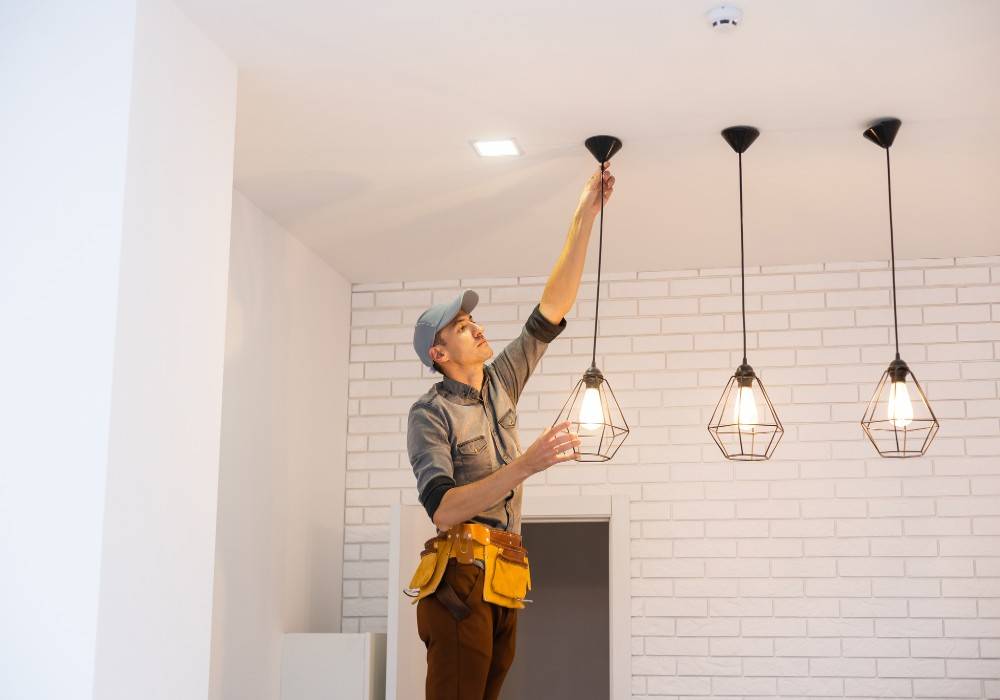 Rob & Son changing high ceiling light bulbs